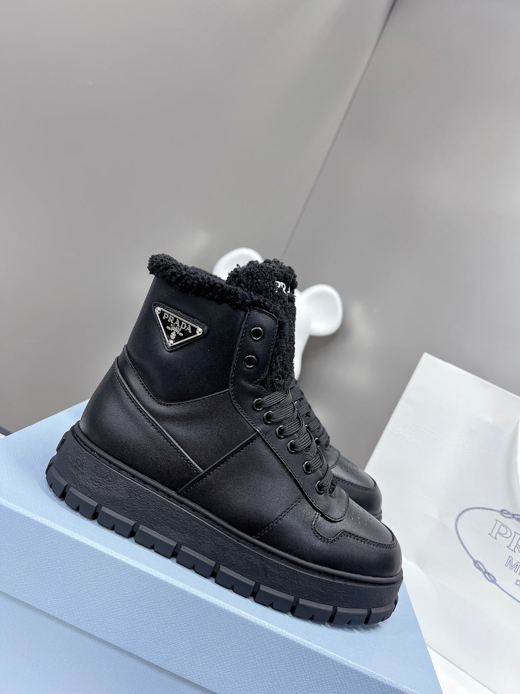 Prada Leather And Shearling High Top  Sneakers