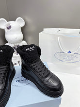 Load image into Gallery viewer, Prada Leather And Shearling High Top  Sneakers
